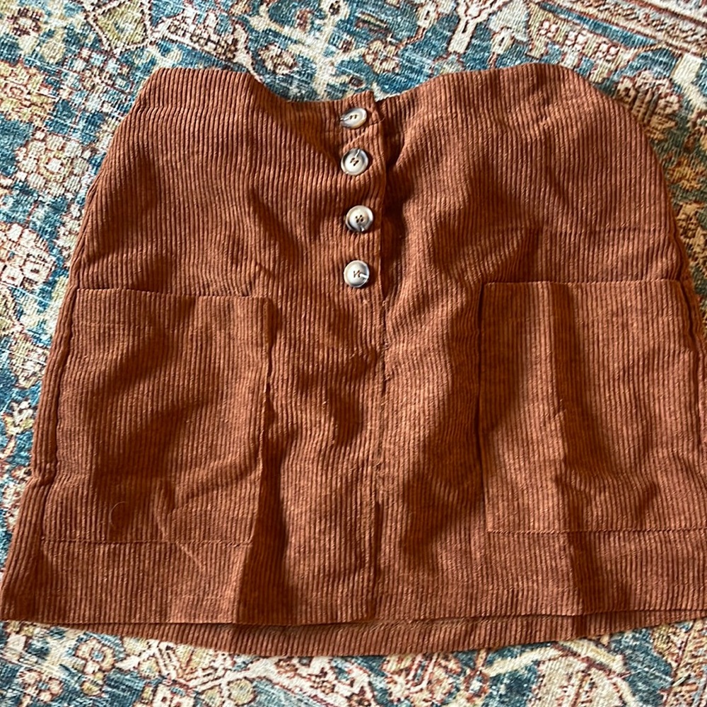 Corduroy, burnt orange skirt.